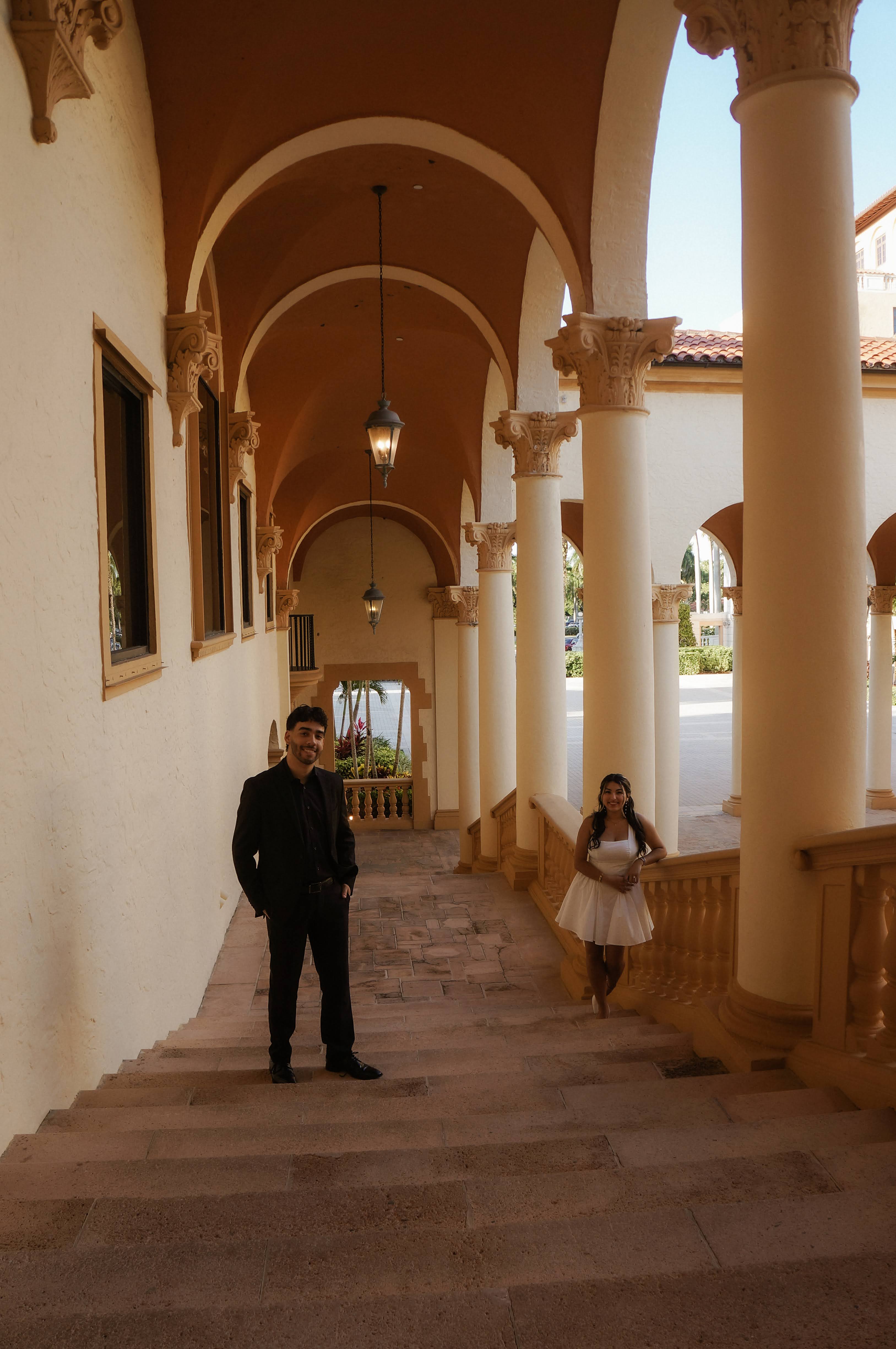 Zamirah and Adriel smiling on the stairs